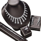 Silver-toned zircon necklace earrings bracelet ring set with floral and rectangular motifs on black mannequin bust