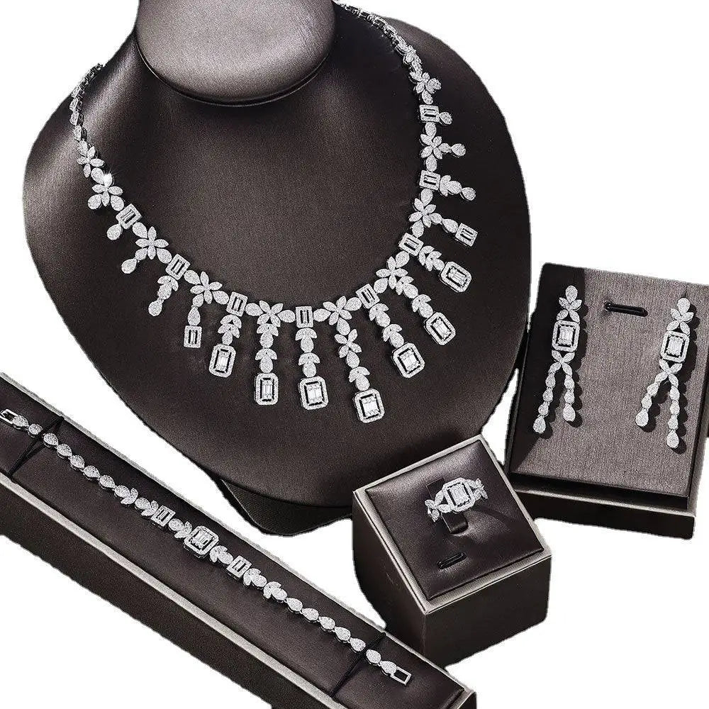 Silver-toned zircon necklace earrings bracelet ring set with floral and rectangular motifs on black mannequin bust
