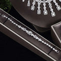 A sparkling silver bracelet with rectangular and teardrop zircon stones in a black velvet box from earrings bracelet ring set
