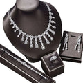 Silver zircon necklace with floral design featuring rectangular and round-cut stones displayed on black mannequin bust