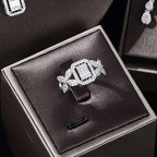 A sparkling silver ring with a central emerald-cut diamond from a zircon necklace earrings bracelet ring set