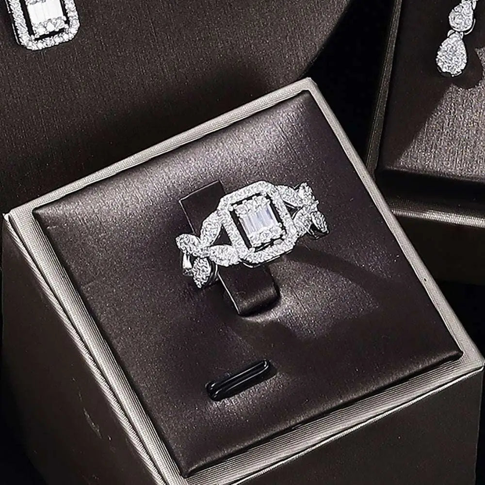 A sparkling silver ring with a central emerald-cut diamond from a zircon necklace earrings bracelet ring set