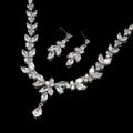 Zircon simple bridal set featuring silver leaf-inspired crystal necklace with matching leaf crystal earrings in clear stones