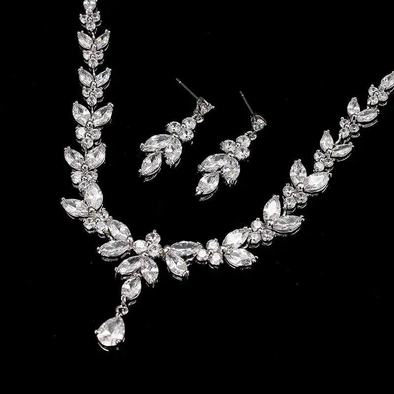 Zircon simple bridal set featuring silver leaf-inspired crystal necklace with matching leaf crystal earrings in clear stones