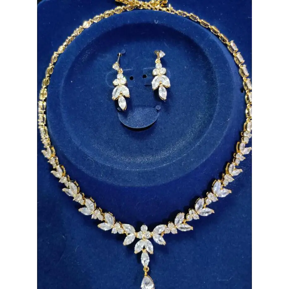 Gold-toned zircon simple bridal necklace with clear leaf-shaped crystals and a dangling teardrop pendant from simple bridal set