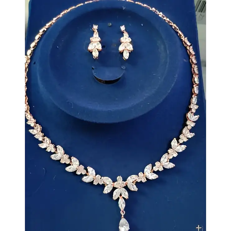 Rose gold leaf crystal necklace with sparkling zircons and teardrop pendant from simple bridal set with leaf crystal earrings
